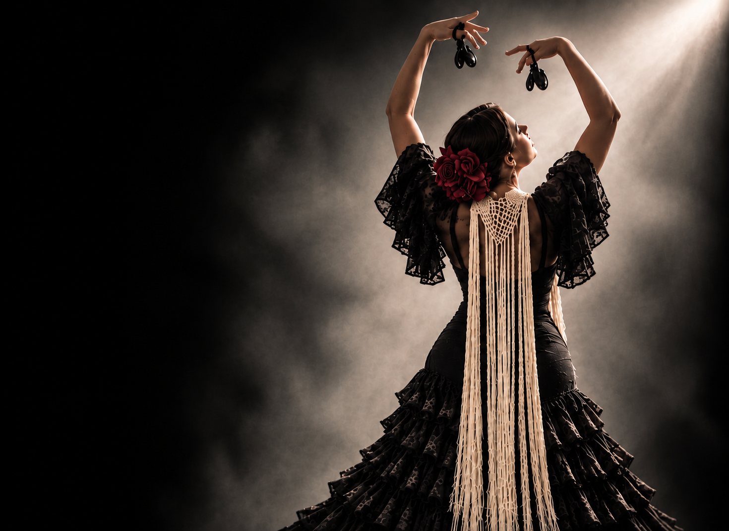 Dancer in black with a cream fringed shawl